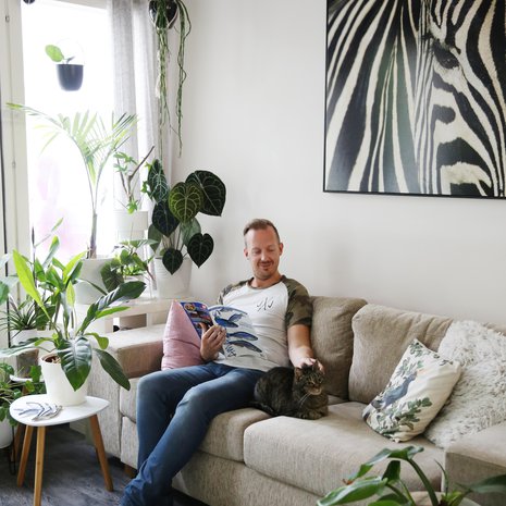 Kotisohvalla voi tunnelmoida trooppisen Amazonin vihreyden ja Afrikan eksotiikan parissa. Juhan seurana on Melody-kissa.