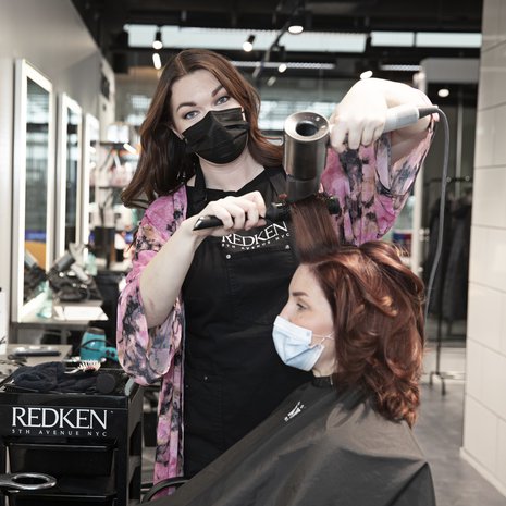 Hanne laittoi asiakkaalleen Annalle tyvivärin, lisää punertavaa. ”Viikonloppuna puhuin teinipoikani kanssa muuttuneista haaveistani. Nuorempana toivoin tunnettavuutta kampaajana itselleni. Nyt haave on päästä luotsaamaan uusia raakileita uralla eteenpäin, kouluttaa uusia kampaajia kansainvälisestikin.”