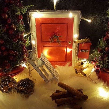 "Rakensin kotiin tonttuoven ja sen ympärille tonttumaailman. Tontun ovi on rakennettu pahvista valokuvakehykseen. Postilaatikko on tulitikkuaski." Johanna Suonpää